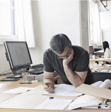 Man reviewing papers at desk